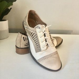 Cream and tan oxford-style shoes with cut-outs